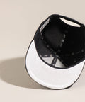 Limited first edition 'A' cap, a classic snapback by Uppr Lowr. The cap features a hand-drawn custom letterform 'A' by Travis Price, exclusive for Uppr Lowr. Crafted from a wool blend, it showcases custom raised embroidery and a deep fit. This collectable cap is a must-have for streetwear enthusiasts.