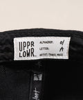 Limited first edition 'A' cap, a classic snapback by Uppr Lowr. The cap features a hand-drawn custom letterform 'A' by Travis Price, exclusive for Uppr Lowr. Crafted from a wool blend, it showcases custom raised embroidery and a deep fit. This collectable cap is a must-have for streetwear enthusiasts.