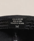 Limited first edition 'A' cap, a classic snapback by Uppr Lowr. The cap features a hand-drawn custom letterform 'A' by Travis Price, exclusive for Uppr Lowr. Crafted from a wool blend, it showcases custom raised embroidery and a deep fit. This collectable cap is a must-have for streetwear enthusiasts.